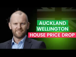 A man smiling with text next to him "Auckland Wellington house price drop"