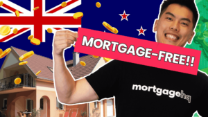 A man smiling holding a banner that says "mortgage free"