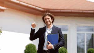 A male property manager walking outside a property. He is holding a set of keys and smiling. This is a picture for a blog post about property managers in NZ